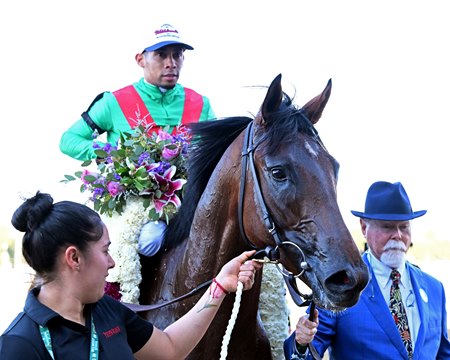 Barry Irwin (right) guides U. S. S. Valor into the winner's circle after the Champagne Stakes at Belmont Park