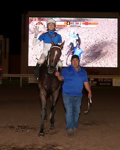 Jockey Erik Asmussen celebrates a five-win evening after winning the nightcap on Pass the Roses at Remington Park